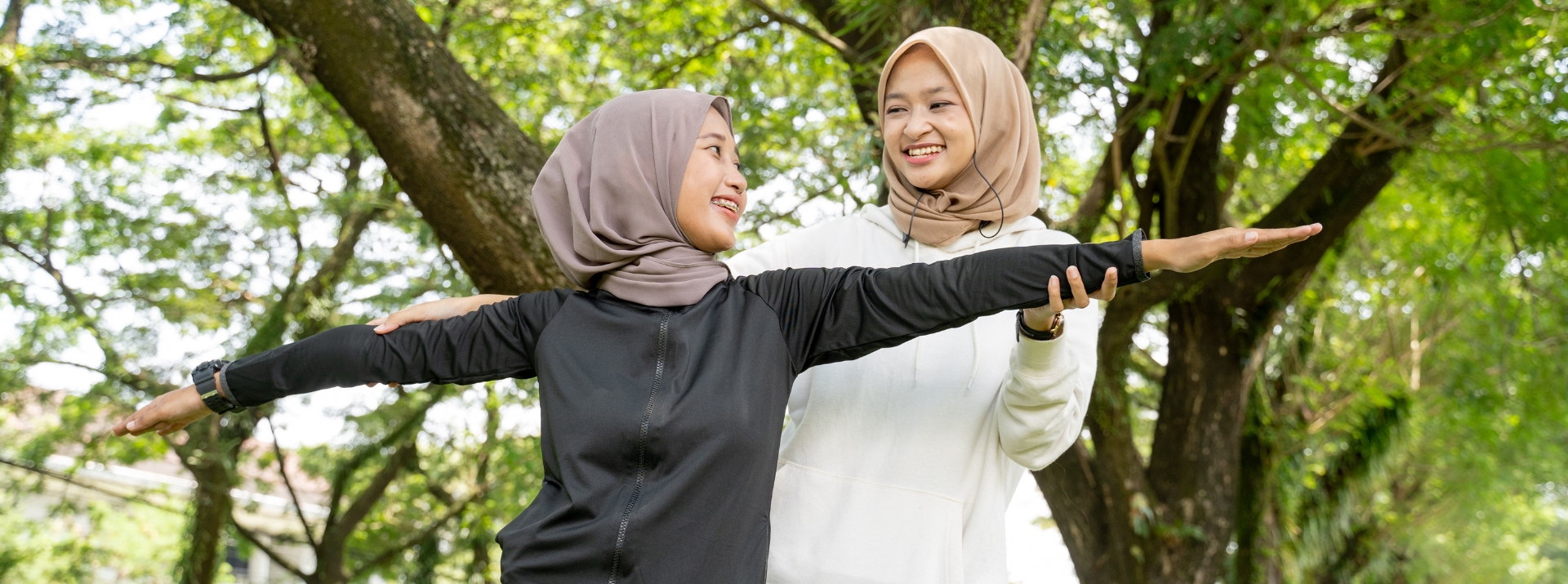 two muslim asian women in the park exercising